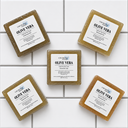 Five bars of Olive Vera soap from COCOLOND Soapery on a tiled surface